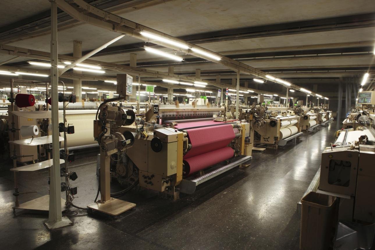 Air-jet weaving looms in a textile factory